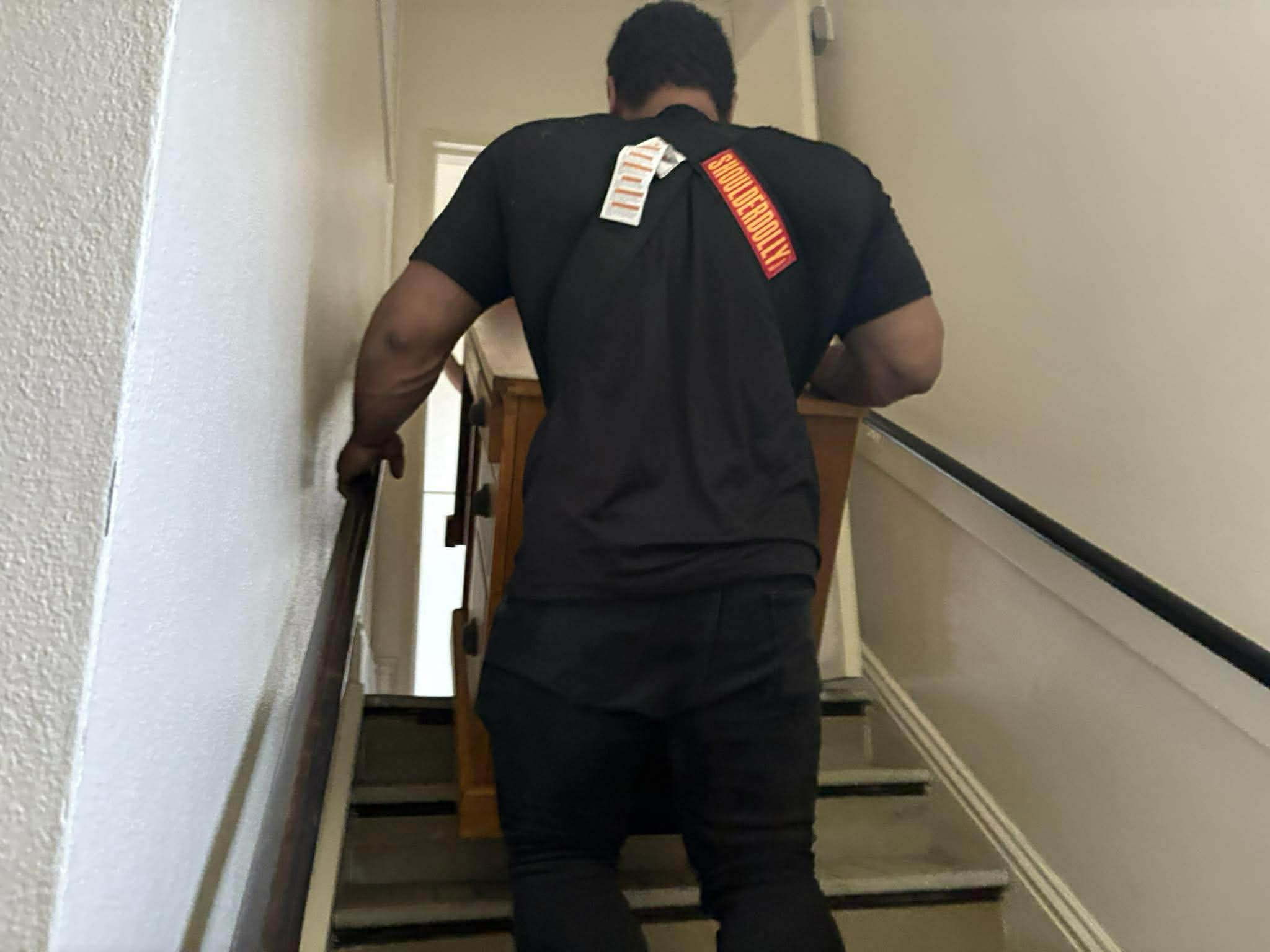 Dakota Moving crew member carrying furniture up a staircase on a Fargo move