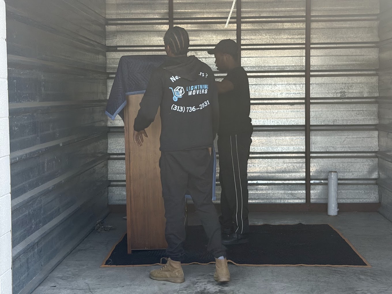 Lightning Movers crew loading furniture into a storage unit